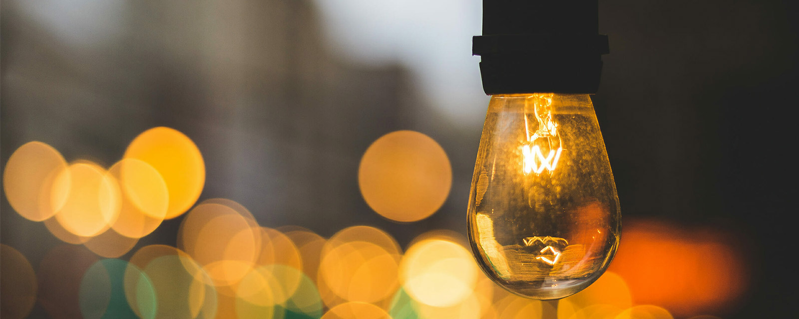 Volunteer management inspiration: Image of a light bulb on a street with a warm glow.